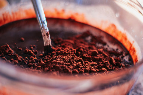 Bowl of cocoa powder being mixed into batter